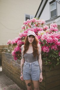 charlie in front of flower bushes